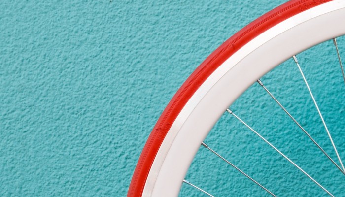 Bicycle wheel against a bright wall