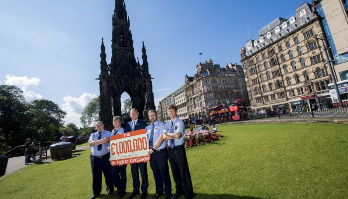 ScotRail Alliance MD standing next to colleagues promoting the giveaway