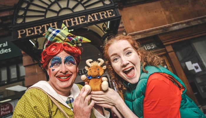 Panto dame and Jack at the front of Perth theatre advertising the pantomime
