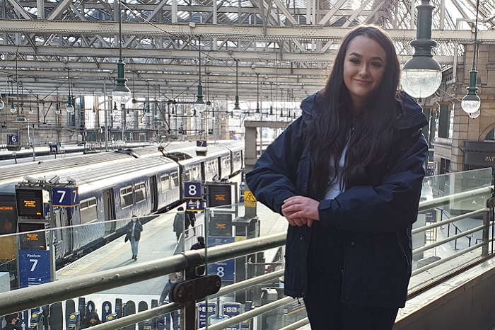 Kiya, customer service apprentice standing in Glasgow Central Station