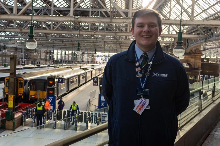 Daniel, customer service apprentice standing in Glasgow Central station
