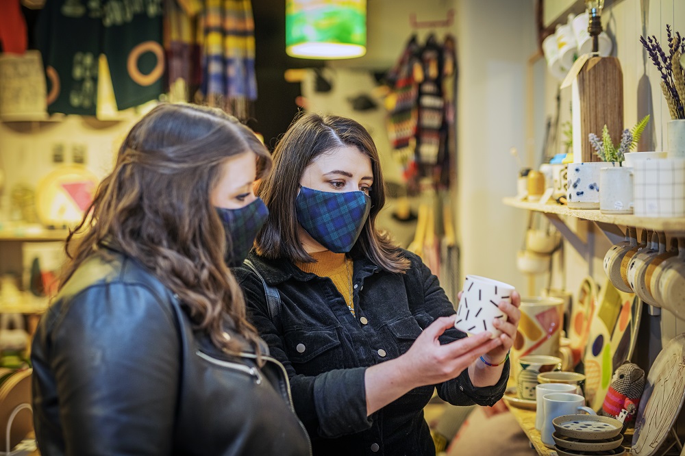 Two ladies wearing masks, shopping at Boo Vake. Image credit VisitScotland and Luigi Di Pasquale