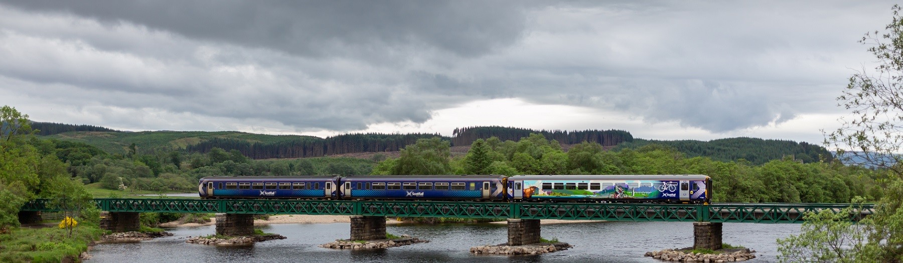 ScotRail Highland Explorer carriage on a bridge over the water