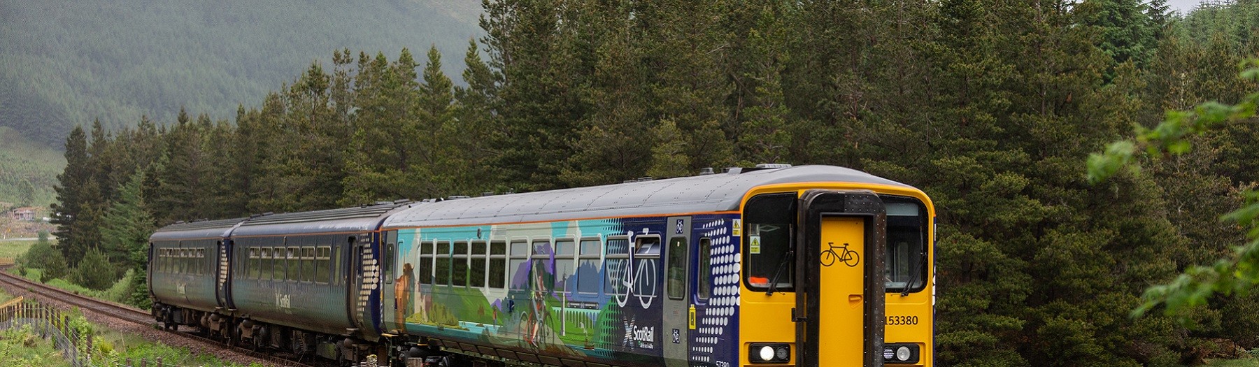 ScotRail Highland Explorer carriage with a scenic backdrop