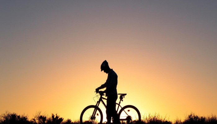 Lone cyclist at sunset