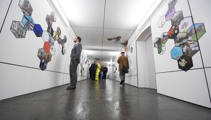 People viewing artwork in Kilmarnock station underpass