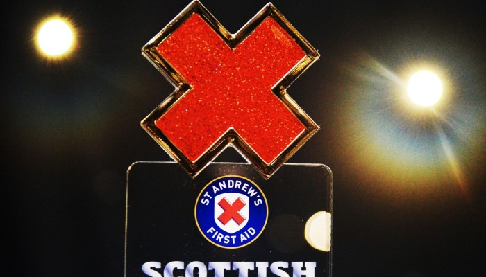 A Scottish First Aid award with red cross at the top