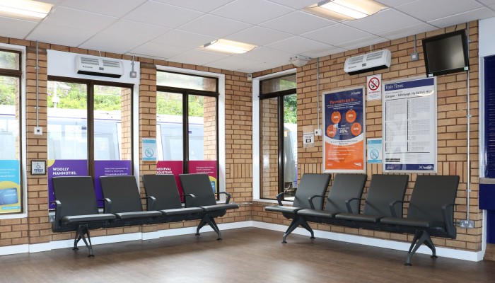 Lounge area at Falkirk High station with padded benches.