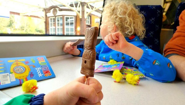 Child on train with chocolate Easter sweet