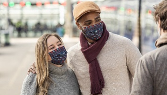 Couple in a station wearing face masks
