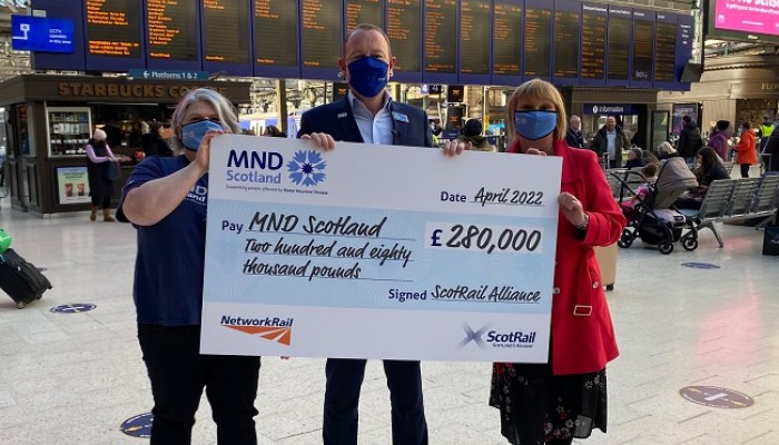 Alex Hynes and ScotRail staff present cheque to MND Scotland