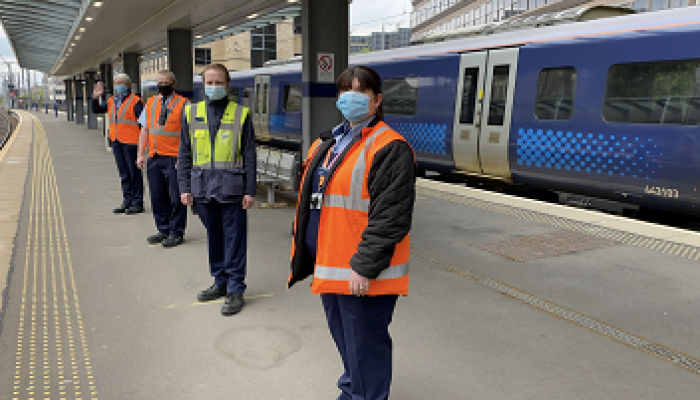 Physical distancing - ScotRail staff next to a train