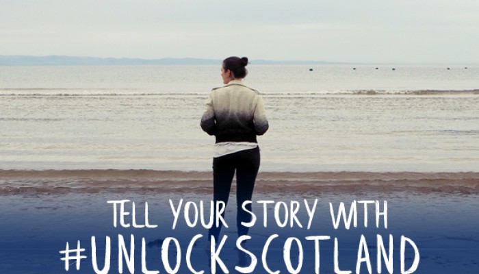 Elle Croft standing on beach - tell your story with #unlockscotland