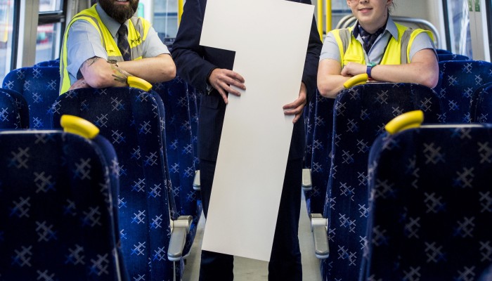 Alex Hynes, ScotRail Alliance Managing Director onboard a train with station team members Paul Brannigan and Kirsty Brown