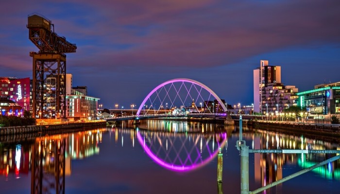 Image of the River Clyde in Glasgow at night, featuring the squinty bridge and ClydePort structure