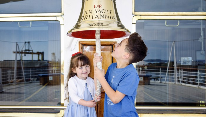 Children ringing bell on Royal Yacht Britannia 