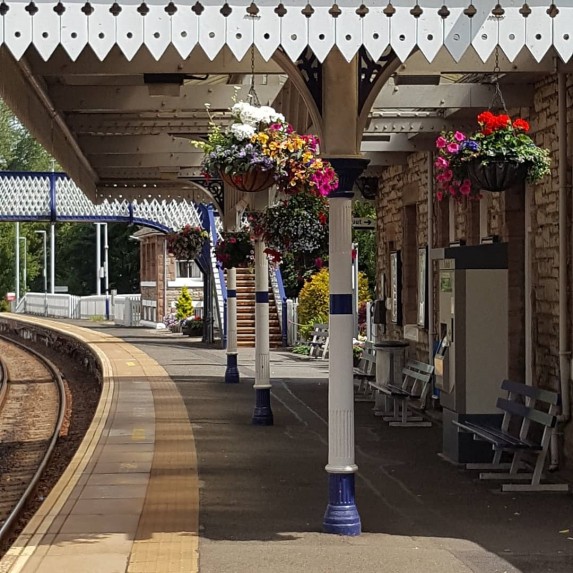 Aberdour station platform with hanging baskets