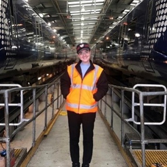 Emma Armstrong standing in a rail depot