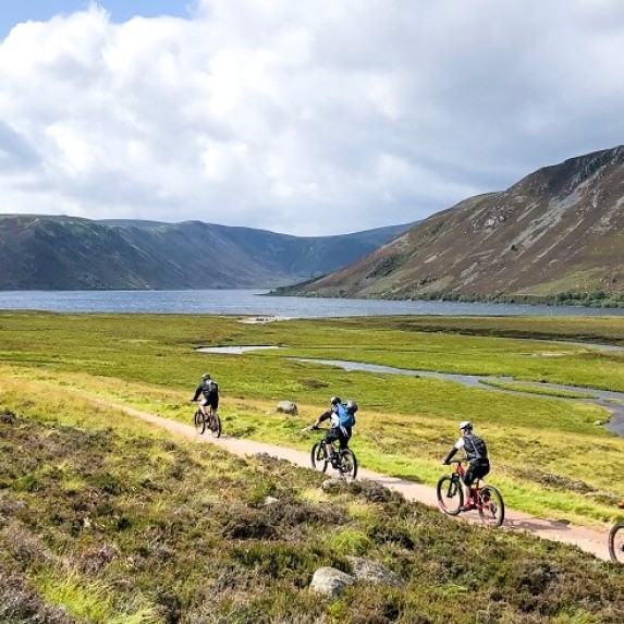 People riding bicycles near Lake Lochnagar