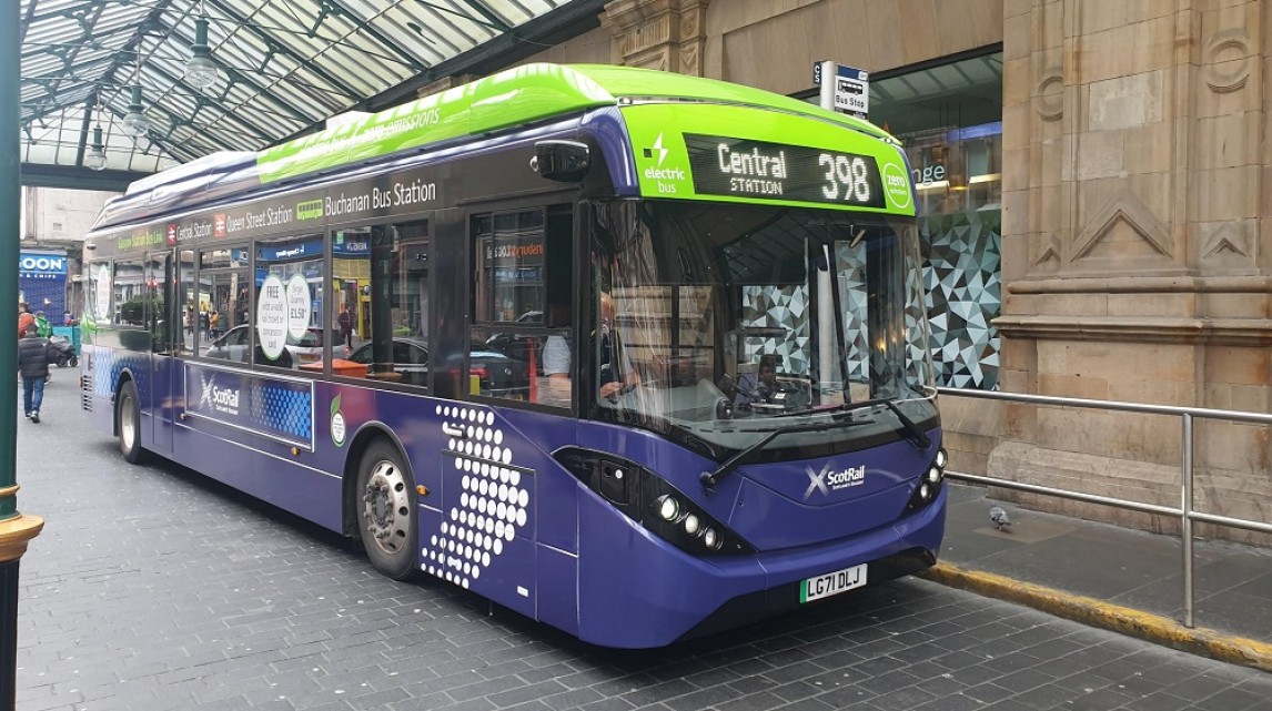 ScotRail branded electric bus waiting outside Central station. 