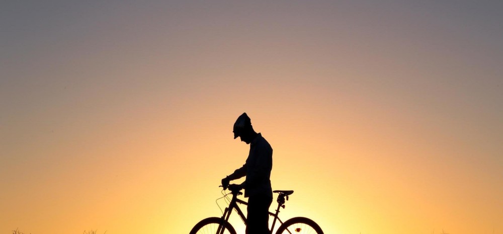 Lone cyclist at sunset
